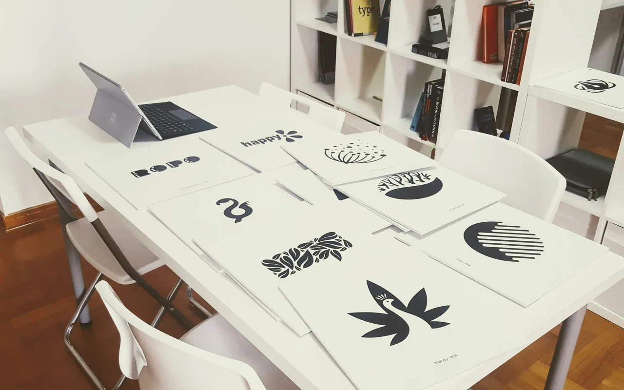 Logo mark exploration cards laid out on a studio table